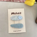 Set of two blue tweed hair clips with button and sequins on a display card - Blue Button Style