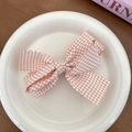 Pink and white plaid bow hair clip with scalloped edges on a decorative white porcelain plate - Pink Plaid