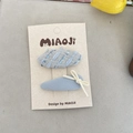 Set of two light blue tweed and sequined hair clips on a cream display card - Bow Style