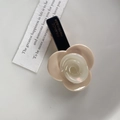 Elegant cream and pearl white acetate flower hair clip with a stylish black base finish - Milk Coffee