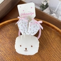 Cute bunny hair clip with floral ears and pink elastic tie on white cardboard - Pink Floral Scrunchie