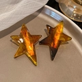 Pair of amber acetate star hair clips with warm marble pattern and glossy finish - Amber