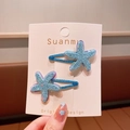 Set of two blue glittery starfish hair clips with metal duckbill base on display card - Blue Hair Clip