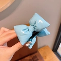 Light blue puffy bow hair clip with glossy metallic finish and 3D ribbon shape - Blue