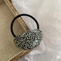 Close-up of acetic acid hair tie with black and white dalmation polka dot pattern - Black Polka Dot