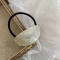 Elegant cream acetate oval hair tie with marble texture on elastic black rubber band - Off White