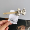 Elegant bow hair clip with black and white marble pattern on a beige acetate base - Beige (X236)