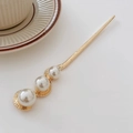 Elegant gold metal hair pin with irregular texture and three cascading faux pearls - Gold