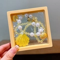Yellow ocean shell beaded bracelet with golden bells in a square display box - Box Packaging / Yellow