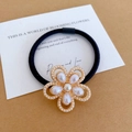 Elegant flower hair tie with white imitation pearls on a golden base with black elastic band - Flower Pearl