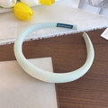 Thick mint green sponge headband with handmade blue label on a decorative wooden table - Padded Handmade Style / Green