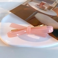 Sweet pink acetate bow hair clip with a translucent jelly finish and golden metal clasp - Pink