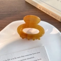 Handmade amber acetate floral hair claw clip in a polished oval cutout design - Caramel color