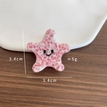 Pink and white marbled acetate starfish hair claw clip with a minimalist black smiley face - Starfish