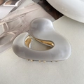 Glossy grey resin hair claw clip with golden metal teeth in a modern streamline design - Gray