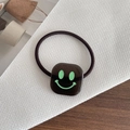 Elastic black hair tie with a square dark brown pendant featuring a green smiley face - Smiley Face Dark Brown
