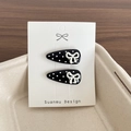 Set of two black polka dot duckbill hair clips with white bows on display card - Black Polka Dot Bow