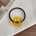 Elastic hair tie featuring a yellow square acrylic charm with a pink smiley face design - Smiley Face Yellow