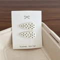 Polka dot hair clips set in creamy white with black spots on display card - White Polka Dot