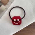 Elastisches braunes Haargummi mit einem roten transparenten Harz-Smiley-Anhänger - Smiley Rot