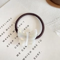 Brown elastic hair tie featuring a butterfly acetate charm with France Handmade text - Aurora White
