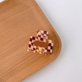 Checkerboard pattern hair claw clip in amber and red tones for half-up hairstyles - Checkered