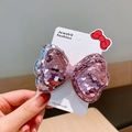 Rosa und lila Pailletten-Haarschleife mit funkelnder Mitte auf weißer Displaykarte - Rosa