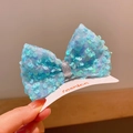 Sparkly blue sequin bow hair clip for girls with a silver glitter center on card - Light Blue