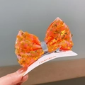 Sparkly orange sequin bow hair clip for girls on a fashion display card - Orange
