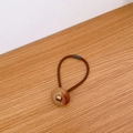 Brown high-elasticity hair tie with amber resin button and gold Love Days detail - Milk Coffee