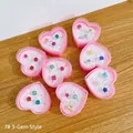 Pink heart-shaped jewelry boxes with 3 gemstone rings for girls on wooden background - Triple Gemstone Style