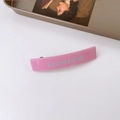 Pink French vintage hair clip with silver larmood lettering on white surface - Pink