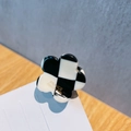 Checkered flower hair claw clip with black and white grid pattern and gold lettering - Checkerboard