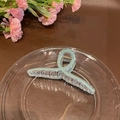 Minimalist light green jelly hair claw clip with a twisted resin design for hair styling - Cyan