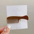 Comb shaped brown hair clip on a white card tray held by a hand showing size details - Brown Comb