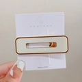 Rectangle hollow hair clip in milk white and brown finish on display card - Off-white Square