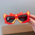 Kids superhero style sunglasses with a red and yellow geometric frame and dark lenses - Red