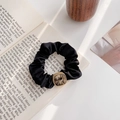 Elegant black satin scrunchie featuring a vintage gold-rimmed resin square charm - Gray