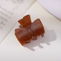 Elegant amber brown acetate bow hair clip with gold lettering for a French style look - Dark Brown