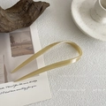 Close-up of minimalist U-shaped hair pin in light khaki acetate with a glossy finish - U-Shaped Hair Pin / Apricot