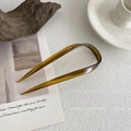 U-shaped amber tortoise shell hair pin on a minimalist aesthetic prop background - U-Shaped Hair Pin / Caramel color