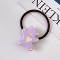 Detailed view of a purple resin cartoon bear hair tie on a minimalist white background - Purple
