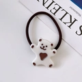 Detail view of a white cartoon bear charm on high-elastic dark brown hair band for girls - White