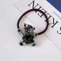 Brown elastic hair tie featuring a marble-textured resin bear with black heart detail - Transparent Black