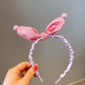 Pink checkered bunny ear headband with purple ruffles and plush pom-poms for girls - Pink