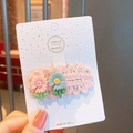 Pink knitted flower hair clip with cute daisies on a handmade display card - Pink