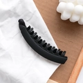 Matte black banana hair clip with strong teeth on neutral aesthetic background - Black