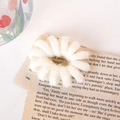 Chouchou spirale en tricot beige élastique avec texture peluche sur livre vintage - Blanc