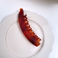 Matte banana hair clip with tortoiseshell pattern in dark brown on a white plate - Matte Tortoiseshell