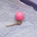 Pink spherical pearl hair accessory with rose gold metal hook on soft white paper - Pink